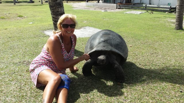 Janice Horton The Backpacking Housewife with a giant tortoise in the Seychelle Islands