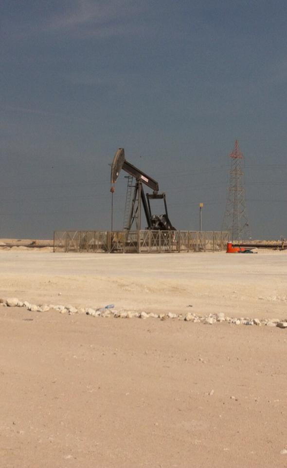 A nodding donkey style oil well in the Bahrain desert oil field