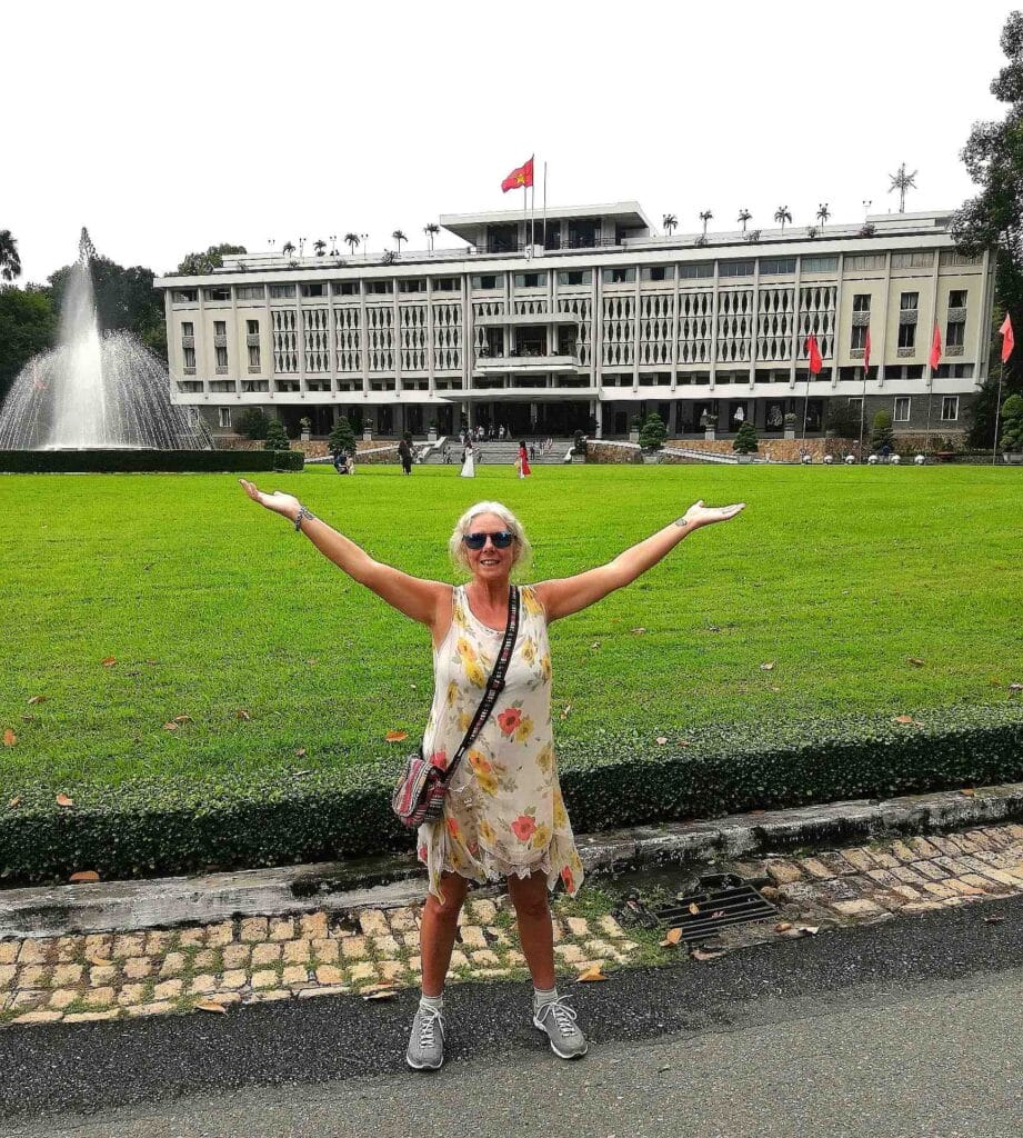Janice Horton on the front lawn in front of the Independence Palace Ho Chi Minh City. The Backpacking Housewife