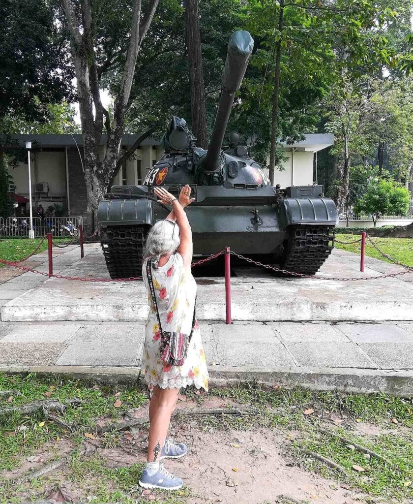 Janice Horton in front of a tank in the grounds of the Independence Palace HCMC