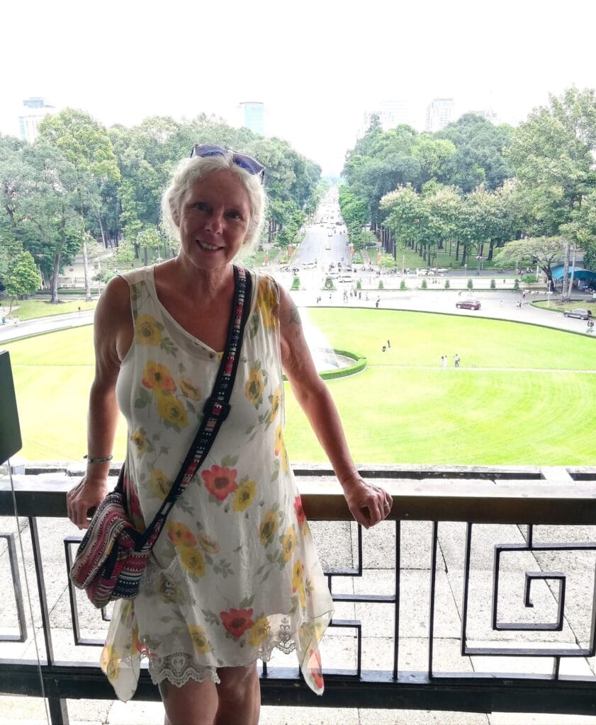 Janice Horton on the front balcony of the Independence Palace Ho Chi Minh City. The Backpacking Housewife