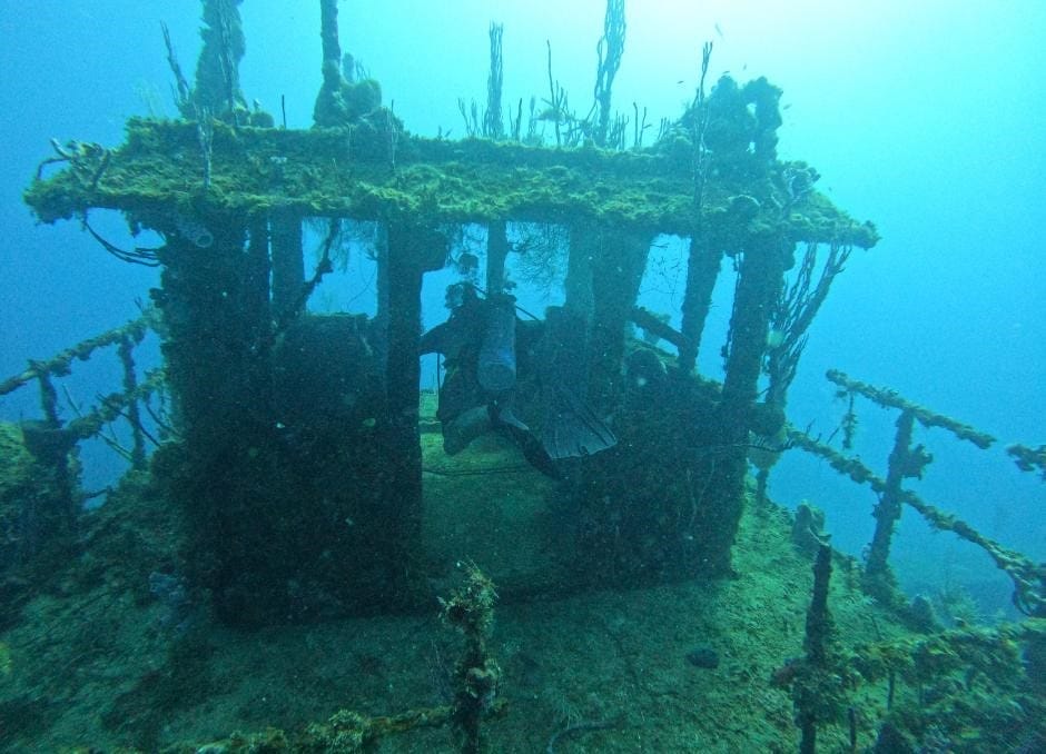 Diving a wreck off Utila Honduras. Wreck Diving is a PADI Qualification. The Backpacking Housewife