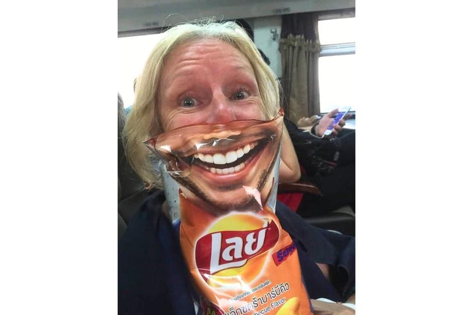 Playing silly games with our empty crisp packets on our journey from Chiang Mai to Bangkok by train