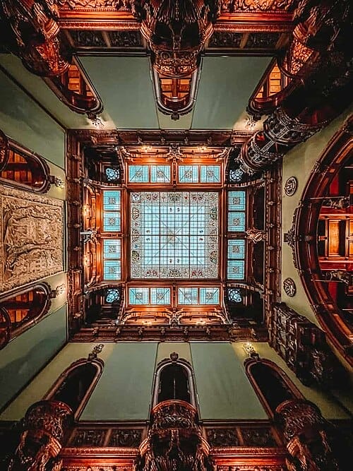 At Peles Castle Romania looking up at the sliding stained-glass ceiling, that guest could look up at to see the stars.