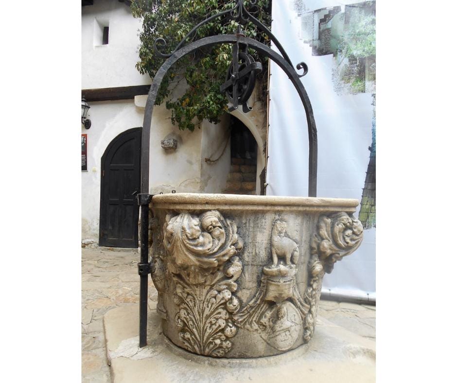 Inside Bran Castle courtyard there is a beautiful stone well